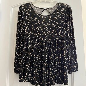 American Eagle Outfitters black flower blouse with open back.